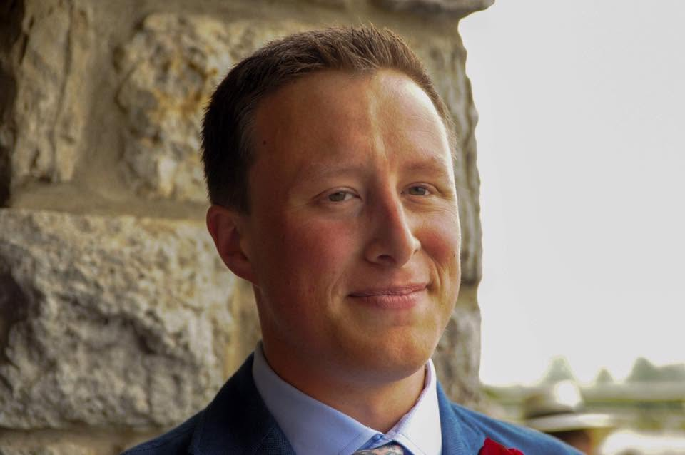 Portrait of Abram Gornik wearing a suit outdoors